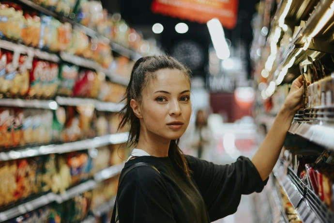 woman shopping in grocery store aisle