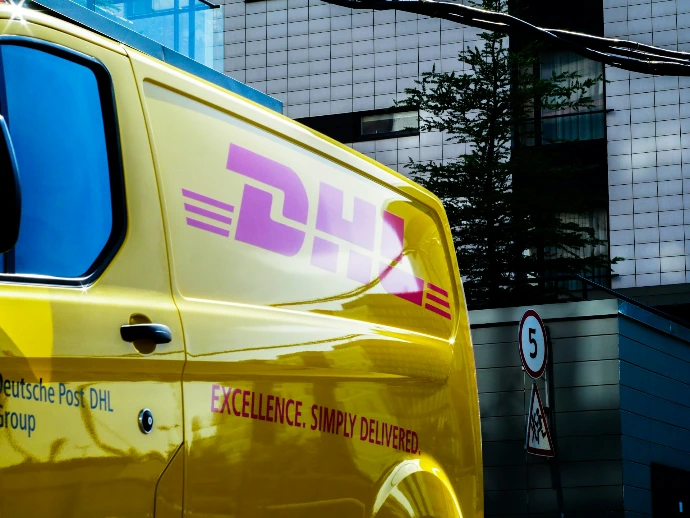 yellow and red vehicle beside building